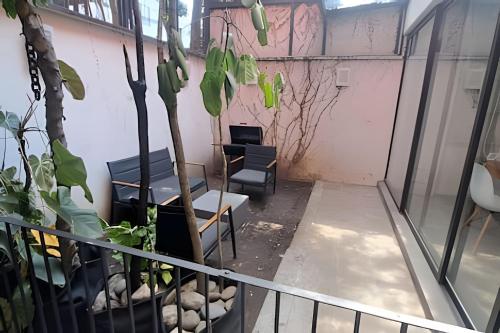 a balcony with chairs and plants in a room at Casona Presa Sanalona No. 12 in Mexico City