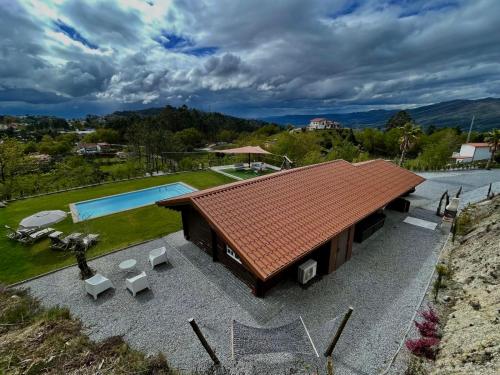 an overhead view of a house with a swimming pool at Chalé da Raposa in Vieira do Minho