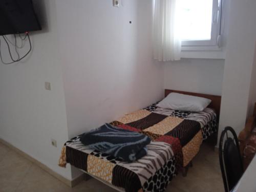 a small room with two beds and a window at Apartment Irina in Ayios Nikolaos Sithonia