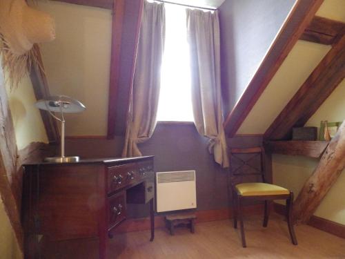 a room with a window and a desk and a chair at Ferme Clatot in Les Trois Pierres