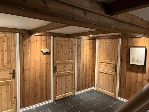 a sauna with wooden walls and tile floors at Large and beautiful cabin in Løfald