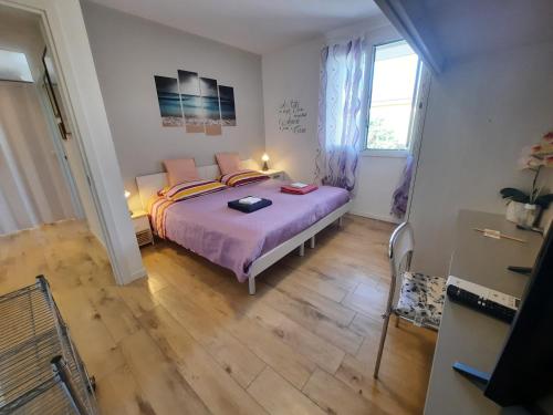 a bedroom with a bed with purple sheets and a window at New Bedrooms Mamma Gigetta in Noventa di Piave
