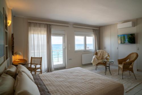 a bedroom with a bed and a table and chairs at Etesians Seaside House in Ágios Konstantínos