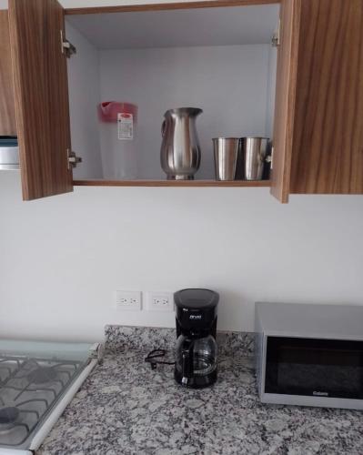 Kuchyň nebo kuchyňský kout v ubytování Departamento para 6 vista al mar con alberca y embarcadero