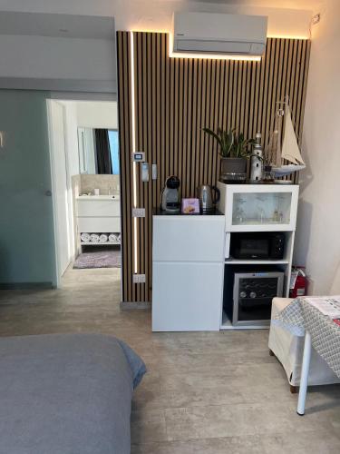 a room with a kitchen with a white refrigerator at SirmioneRooms in Sirmione