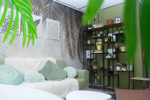a living room with a couch and a book shelf at Jungle & Orange Box - Studio - Navodari in Năvodari