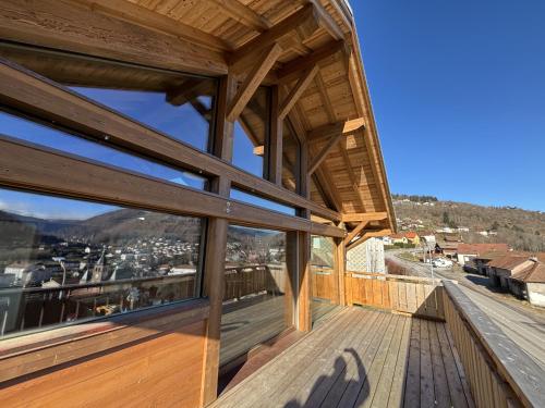 a view from the balcony of a house with a roof at Lumen Wood in La Bresse