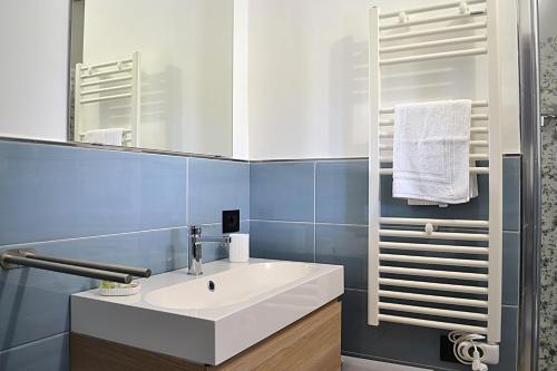 a bathroom with a white sink and a mirror at Zenia Rooms in San Teodoro