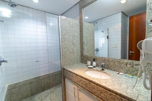 a bathroom with a sink and a mirror at Ozped Private Flats Comfort Suites in Brasília