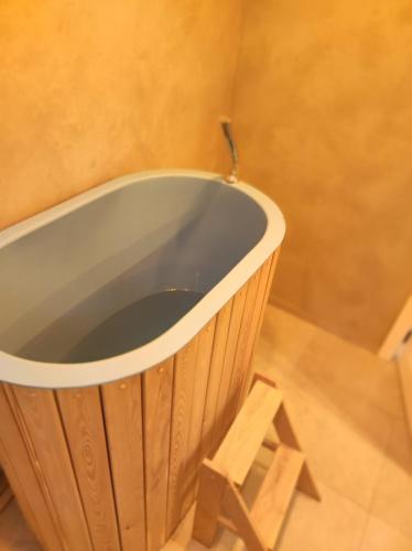 a wooden bath tub sitting on top of a floor at New Gudauri Rooms in Gudauri