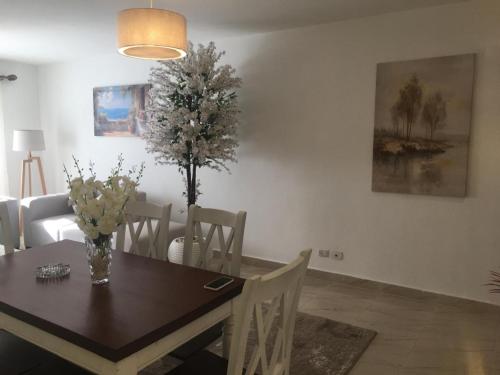 a dining room with a wooden table with a tree on it at Casa De Madinaty -مدينتي in Madinaty