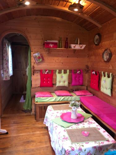 une chambre avec deux lits dans une cabane en rondins dans l'établissement Duccio Cabana Hébergements Insolites, à Potelle