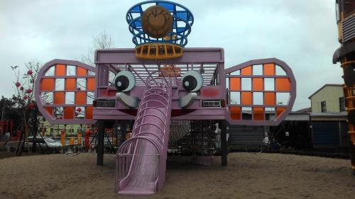 a playground with a slide in the sand at Time Travelodge Homestay in Zhuangwei