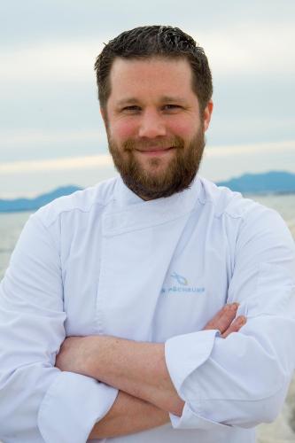 a man in a chef uniform standing with his arms crossed at Cap d'Antibes Beach Hotel in Juan-les-Pins