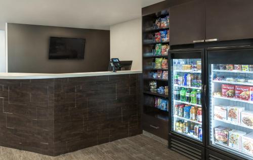 a drink station in a store with a refrigerator at My Place Hotel-Altoona/Des Moines, IA in Altoona