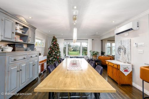 a kitchen with a wooden table and a christmas tree at Couple's Oasis at Horner Park in Victoria