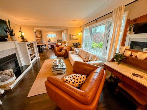 a living room with leather furniture and a fireplace at Couple's Oasis at Horner Park in Victoria