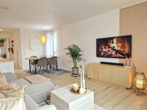 a living room with a large flat screen tv on a wall at WillingenHOME in Willingen