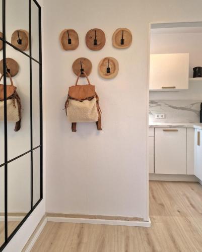 a room with a wall with hats and a purse on it at WillingenHOME in Willingen