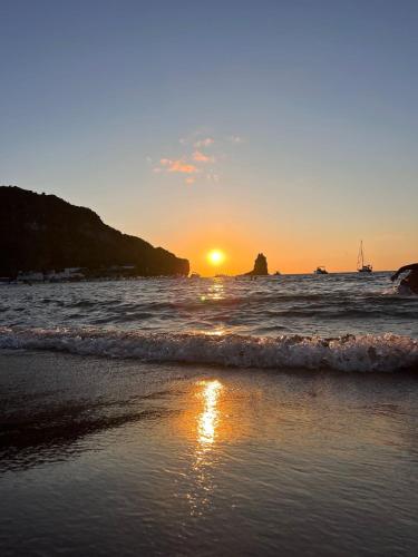 a sunset on a beach with the ocean at Lipari Centro Storico 5 mins from port Casa Celeste in Lipari
