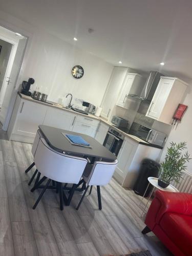 a kitchen with a table and chairs in a room at 4 star Rating 2 bed Newly renovated city apartment with free parking in Belfast
