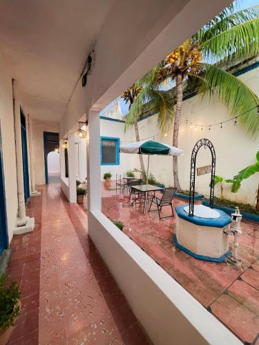 a resort hallway with a hot tub and a palm tree at Villa Mediterranea in Campeche