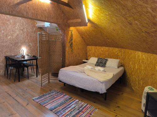 a bedroom with a bed and a table in a room at Aveiro Train Studios in Aveiro