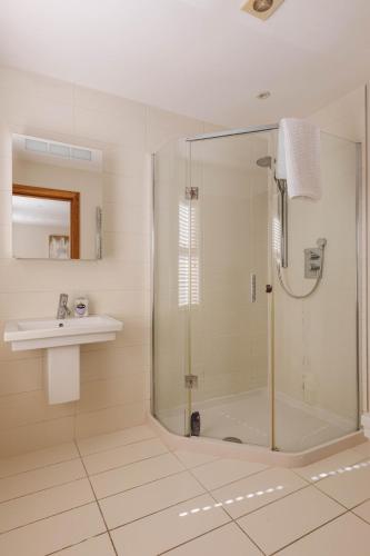 a bathroom with a shower and a sink at Tobela House, Sleeps 10, Ultra Luxury in Lambeg