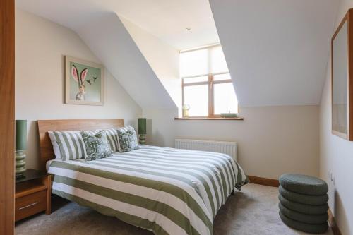 a bedroom with a bed and a window at Tobela House, Sleeps 10, Ultra Luxury in Lambeg