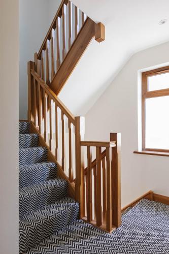 a staircase in a house with a rug at Tobela House, Sleeps 10, Ultra Luxury in Lambeg
