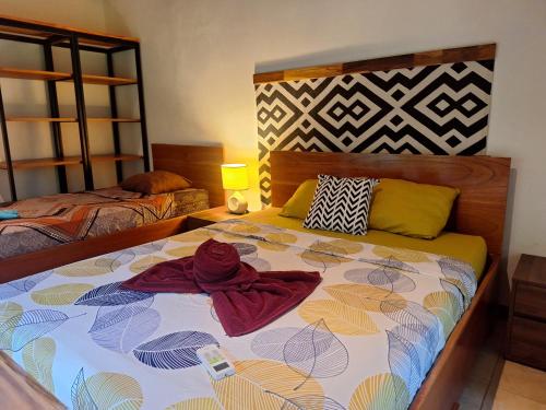 a bedroom with a bed with towels on it at Corcovado Accommodations-pool-best views-nature in Puerto Jiménez