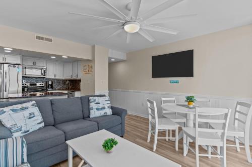 a living room with a couch and a table at Paradise Towers #104 in Carolina Beach