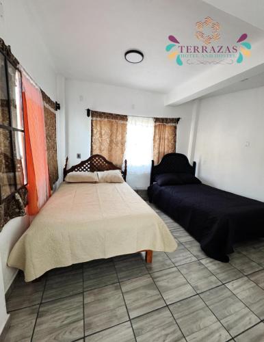 a bedroom with a bed and a couch at Terrazas Hotel and Hostel in Taxco de Alarcón