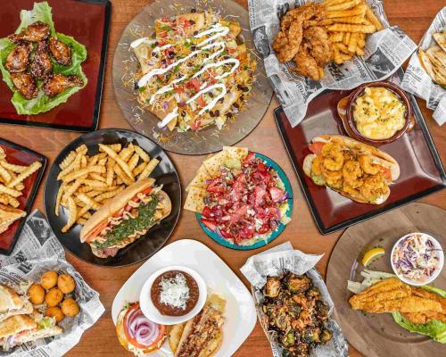 a table full of different types of food on plates at Double Take! Renovated Vacation Home in Panama City Beach