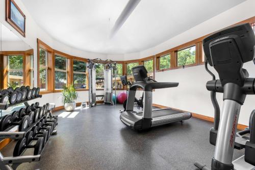 a gym with treadmills and exercise equipment and windows at Best Western Driftwood Inn in Idaho Falls