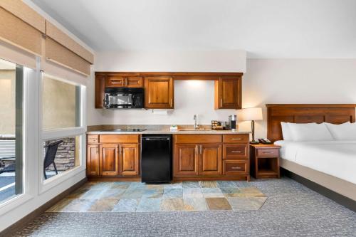 a bathroom with a bed and a kitchen with a sink at Best Western Driftwood Inn in Idaho Falls