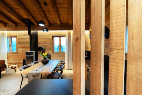 a dining room with a table and chairs and wooden walls at Agri Alloggio La Quercia e il Frassino in Fino del Monte