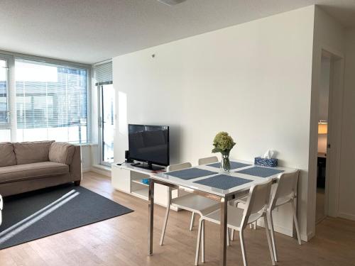 a living room with a table and a couch at Amazing brand new 2bedr&2bathr in Richmond center in Richmond