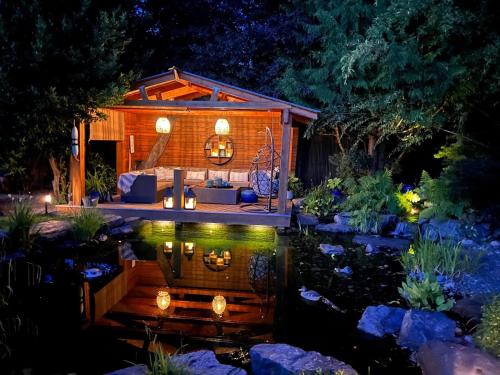 a backyard garden with a tiny house and a pond at Couple's Oasis at Horner Park in Victoria