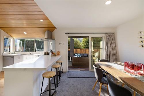 a kitchen and dining room with a table and chairs at Arrowtown Family Home with spa in Arrowtown