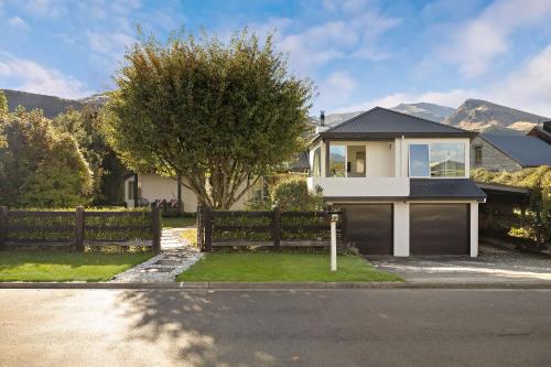 a house with a fence in front of it at Arrowtown Family Home with spa in Arrowtown