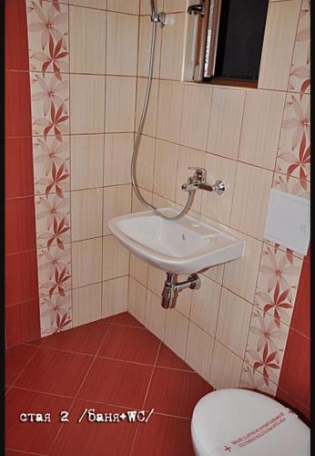 a bathroom with a sink and a toilet at Лорета-Камен бряг in Kamen Bryag