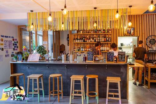 a bar in a restaurant with people standing at a counter at La Grange à Gaby in Engins