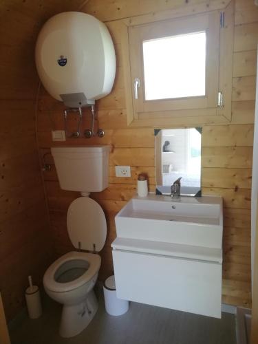 a bathroom with a toilet and a sink and a window at Glamping Subiaco- Casina Valentina in Subiaco