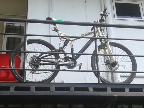 a bike chained to a rail next to a building at Mini's Residence in Colombo