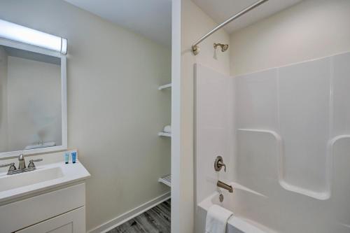 a white bathroom with a sink and a shower at 3006 Queen Suite, 3rd Floor Cove in Surf City