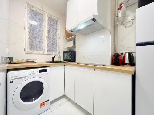 une cuisine blanche avec une machine à laver à l'intérieur dans l'établissement Cozy Ap des Gobelins, à Paris