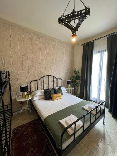 a bedroom with a large bed in front of a brick wall at Hotel Ambra Milano in Milan