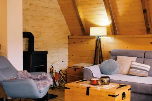 a living room with a couch and a table at Owl House Jelovica in Berane