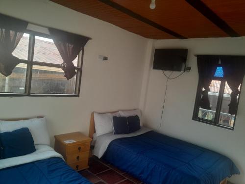 Ein Bett oder Betten in einem Zimmer der Unterkunft Hotel Mahoma